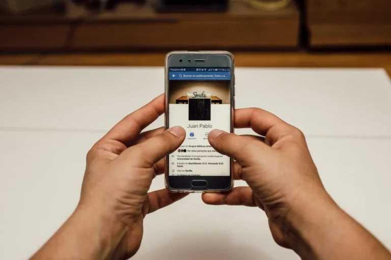 Hands testing a mobile app on a smartphone