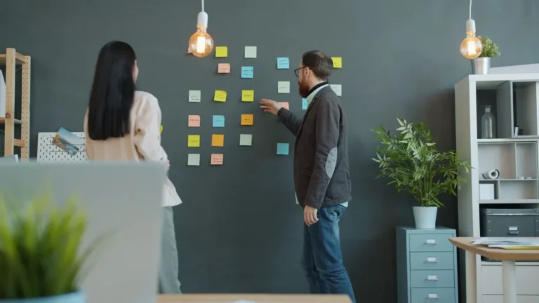Team planning a project on a wall of sticky notes