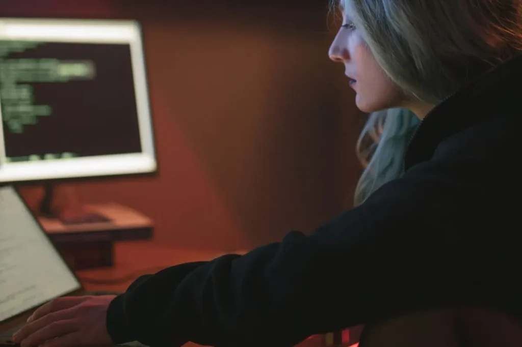 Developer working late with code on screen