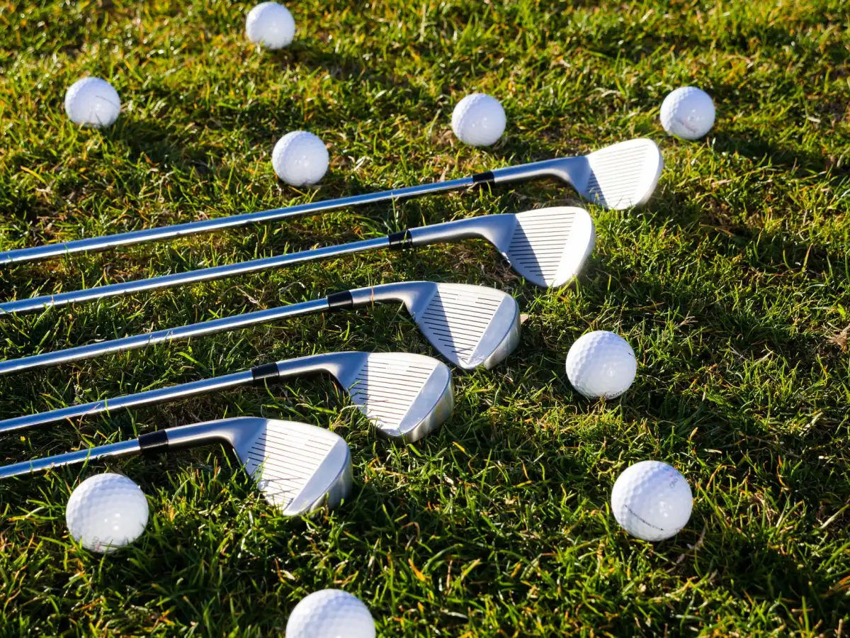 Golf clubs and balls on a green