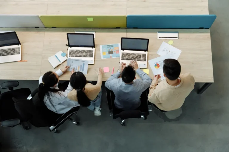 Product team working together on laptops
