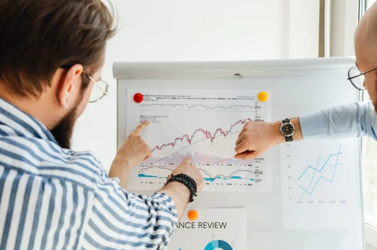 Strategist presenting performance charts on a whiteboard